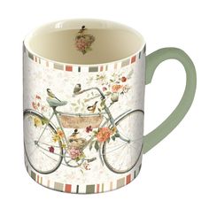 a coffee mug with birds and flowers on the handle, sitting in front of a white background