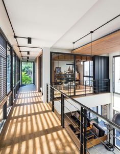 the inside of a house with lots of windows and sliding glass doors on both sides