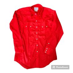 PEARL SNAP Western Shirt Vintage 70s Size Medium Size 16 Rockmount Ranch Wear Brand Diamond Snaps Red Cowboy Long Sleeve Button Up Made in USA A beautiful, bold red western style shirt with unique, diamond-shaped pearl snaps up the front, on cuffs, and pockets. Double-peaked, sawtooth chest pockets and double-peaked yoke on the back.  Brand: Rockmount Ranch Wear Tag Size: 16 (men's medium) Measurements available upon request. In great condition overall. No holes or stains. All snaps intact. Western Style Red Long Sleeve Tops, Red Western Long Sleeve Tops, Red Long Sleeve Western Top, Fitted Red Tops With Snap Buttons, Classic Red Tops With Snap Buttons, Western Red Tops For Spring, Western Style Red Tops For Spring, Spring Western Red Tops, Vintage Red Tops For Rodeo