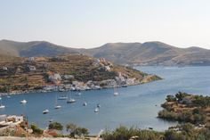 boats are in the water near some hills