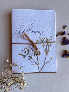 a card with wildflowers tied to it