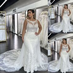 a woman in a white wedding dress standing next to a rack of dresses and looking at the camera