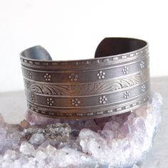 Elaborately engraved silver plated cuff bracelet is in a Victorian style with a central band of acanthus leaves flanked by bands of tiny ridges, flowers, milgrain engraving and a dentille border. The engraving is definitely a cut above what is normally seen on this type of bracelet. It has a lovely, lightly tarnished patina. Size: About 7 interior circumference (including the gap) and 1 inch wide. Age: Unknown, but my hunch is about 1970s, when Victorian style was very popular. Materials: Silver plated base metal. Not attracted to a magnet. Marks: Unmarked Condition: Excellent pre-owned condition. Light tarnish. Plating is in good condition, no bare spots. SHIPPING INFO: This item ships for free to the United States. I use Calculated Shipping for international orders. If I can ship for les Engraved Cuff, Acanthus Leaves, Victorian Revival, Sterling Silver Brooch, Pink And White Stripes, Acanthus Leaf, Hinged Bracelet, Sterling Silver Cuff Bracelet, Silver Engraving