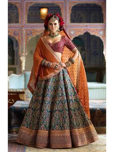 Look stunning in this Blue and red Embroidered Designer sabyasachi bridal wedding Lehenga Choli. The lehenga is made of Mulbury Silk fabric that has been enhanced with lovely heavy floral embroidery all over with stone embellishments. It Comes along with unstitched red Mulbury Silk blouse piece with Thread, Dori, Zari, Sequins Embroiderey with stone work. It has embroidered lace soft netted Orange colored dupatta to complete the look  Price:$66.50 Wedding Lehenga Sabyasachi, Sabyasachi Bridal Lehenga, Lehenga Sabyasachi, Sabyasachi Lehenga Bridal, Sabyasachi Bridal, Sabyasachi Lehenga, Bollywood Lehenga, Designer Bridal Lehenga, Indian Bridal Lehenga