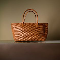 Embrace style with the intricate basket weave design that adds a touch of artisanal charm to your ensemble. The large capacity of this bag ensures that you carry all your essentials, making it perfect for any occasion. Its lightweight materials make it a breeze to carry. Now available in black, caramel, brown, and army green. Luxury Satchel With Braided Handles For On-the-go, Elegant Straw Tote Bag For On-the-go, Woven Leather Hobo Tote Bag For On-the-go, Woven Leather Satchel For On-the-go, Everyday Leather Woven Bag, Woven Leather Bags For Everyday Use, Luxury Crochet Tote Bag With Intrecciato Weave, Everyday Rectangular Woven Leather Bucket Bag, Woven Leather Bag With Double Handle