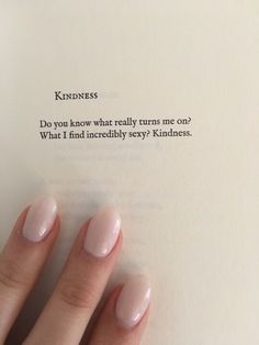 a woman's hand with pink nail polish holding an open book that says, kindness do you know what really turns me on?