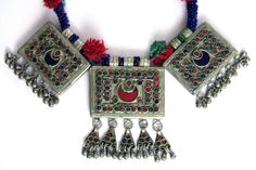 This old Afghan necklace with rectangular pendants and beaded band was handcrafted during the mid-1900's for the nomadic Kuchi tribe of Central Asia. It is vintage tribal jewelry - not a new reproduction. MEASUREMENTS (1 inch = 2.54 cm): Length = 23 inches Center pendant dimensions = 3-1/2 inches long x 2-3/4 inches wide x 1/4 inch thick Weight = 6.9 oz Shipping Weight = 13 oz TM Image library 12-30-2020 At 1/4 inch thick, the large rectangular pendants are hollow, with large blue and red cresce Afghan Necklace, Mount Dora, Afghan Jewelry, Vintage Afghan, Central Asia, Jewelry Cleaner, 1 Inch, Crochet Necklace, 4 Inch