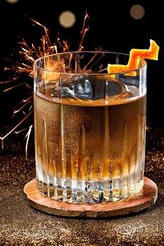 an old fashioned cocktail is garnished with orange peels