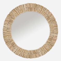 a round mirror made out of woven material with an oval frame in the shape of a circle