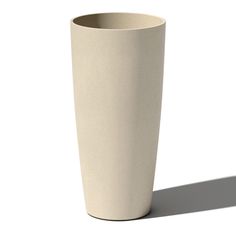 a tall white cup sitting on top of a table