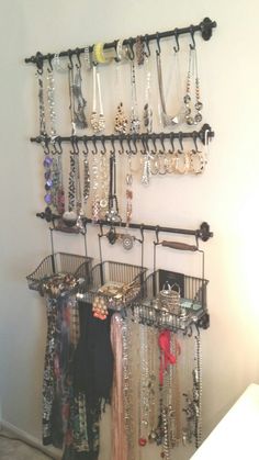 there is a rack with many necklaces and bracelets hanging from it's sides