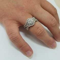 a woman's hand with a diamond ring on it