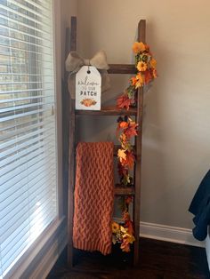 a ladder is decorated with fall leaves and flowers