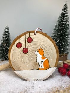 a wood slice with a fox and berries on it