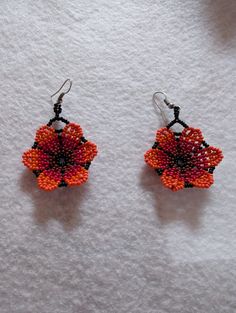 Add to your style with these beautiful handmade flower earrings! Orange Beaded Flower Earrings, Handmade Elegant Flower Pendant Earrings, Red Flower Charm Earrings, Red Flower Earrings With Ear Wire, Handmade Cluster Earrings As Gift, Unique Flower Charm Dangle Earrings, Handmade Red Flower Beaded Earrings, Unique Dangle Flower Charm Earrings, Red Handmade Flower Earrings