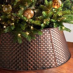 a christmas tree in a basket on the floor