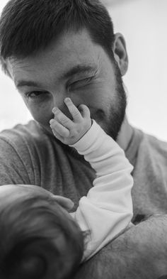 a man holding a baby in his arms