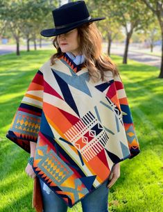 "Fire Legend Poncho Made from the Fire Legend wool blanket by Pendleton® Woolen Mills, this poncho is full of vibrant color and geo patterns. Based on a Native American legend, the pattern honors a victorious hero that disguised himself to capture fire for his people. Pull this poncho over your head and you're ready to go. Sleeveless and roomy for an easy-to-wear style with plenty of warmth. Blanket weight, whipstitch trim, closed collar. One size. Reversible. * 82% pure virgin wool / 18% cotton New Mexico Style, Native American Legends, Cowboy Aesthetic, Blanket Poncho, Pendleton Woolen Mills, American Legend, Wool Poncho, Pendleton Wool, Wool Vest