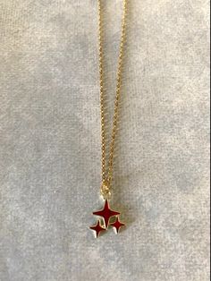 "Dainty, attractive and unique gold tone and red polar stars necklace. Pendant is small measuring 1/2\" L X 1/2\" W and is on an 18\" chain. ★ Want to see more? Please visit my shop at: https://www.etsy.com/shop/DesignsByPeg" Red Star Necklace, Gold Star Jewelry, Star Jewellery, Red Pendant Necklace, Stars Jewelry, Gold Star Pendant, Cute Necklaces, Stars Necklace, Pretty Accessories