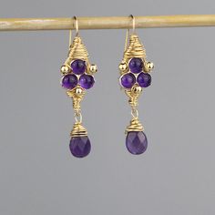 "Amethyst Jewelry, Gemstone Jewelry, Amethyst Third Eye Earrings, Gold Filled Jewelry, Meditation Jewelry, Handmade Amethyst Jewelry Cosmic third eye earrings are made of natural purple amethyst gemstones set on silver bezel and hand twisted gold filled wire around it. Gold filled beads are interwoven gently, and a beautiful faceted amethyst drop dangles down. The hook is made of gold filled. The \"third eye\" is referred as the intuitive spiritual eye, or the eye of the soul. It is associated w Purple Amethyst Gemstones With Accents, Purple Amethyst Birthstone Earrings, Handmade Amethyst Teardrop Gemstones, Handmade Teardrop Amethyst Gemstones, Purple Amethyst Teardrop Gemstone, Purple Teardrop Amethyst Gemstone, Wedding Amethyst Earrings With Natural Stones, Handmade Gold Amethyst Gemstones, Lavender Amethyst Earrings With Gemstone Accents