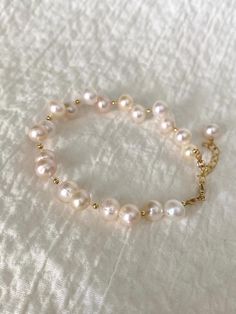 ✨ Welcome to The Pearly Loft ✨ Introducing 💖 Ariel 💖 - our stunning Freshwater Pearl Bracelet featuring an elegant Irregular Pearl design with 14K Gold Filled components. This Baroque Pearl Bracelet is perfect as a Bride Bracelet or a beautiful addition to your Minimalistic Jewelry collection. The Delicate Bracelet design is ideal for those who appreciate understated elegance and Boho Wrislet style. Handcrafted with care, Ariel showcases the natural beauty of Real Pearl Bracelet with its unique irregular pearls. The 14K Gold Filled accents add a touch of luxury, making this Elegant Bracelet a standout piece for any occasion. Whether you're looking for a versatile Everyday Bracelet or a Cute Wristlet to complement your outfit, Ariel is designed to impress. ✨ Details: - 6" inches + 2" inch Handmade Cute Pearl Bracelet, Dainty Pearl Bracelet For Jewelry Making, Hand-strung Pearl Bracelet Gift, Handmade Yellow Gold Pearl Bracelet For Wedding, Elegant Gold Hypoallergenic Rosary Bracelet, Elegant Hand-strung Charm Bracelet, Gift Single Strand Round Gold Bracelet, Hand-strung Pearl Bracelet, Elegant Hypoallergenic Gold Rosary Bracelet