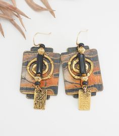 Listing is for a Vintage Artisan Chinese safari print bronze architectural tribal earrings.  Very nicely made earrings with black onyx? accent and dangle drop Chinese hieroglyph symbol. Earrings have safari print, bronze and paper coated with paint. Earrings measure 2.4" x 0.9".  Good vintage condition! thank you. (N132) Artistic Black Jewelry With Matching Earrings, Artistic Black Dangle Jewelry, Artistic Black Dangle Earrings, Black Artistic Jewelry, Black Jewelry With Artistic Design, Artistic Black Drop Earrings, Black Earrings With Artistic Design For Gift, Black Earrings With Artistic Design As A Gift, Artisan Black Dangle Earrings