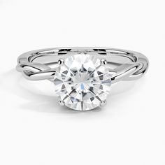 a round brilliant cut diamond engagement ring on a white background with the center stone visible