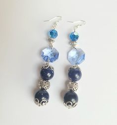 Benefit from the calming color of blue. You're looking at a lovely pair of handmade ear rings comprising two 10 mm sodalite beads on each piece, decorated with intricate silver bead caps.  Each piece is further accented with one blue hexagonal Swarovski crystal and a sapphire blue crystal, along with intricate spacers. Definitely a statement piece! Flaunt this pair at a party or to dinner.  This beauty is 7 cm long, from the base of the ear wire.  Healing properties: Sodalite promotes self expression and communication, giving the wearer a renewed sense of self-esteem. Thank you for looking at this listing at Crystal Bijoux by Emmie. You can explore all our handmade, one-of-a-kind, crystal jewelry collection here:  https://www.etsy.com/shop/crystalbijouxbyemmie We also custom make crystal j Crystal Dangle Earrings As Gift, Crystal Dangle Earrings For Gift, Elegant Dangle Earrings With Faceted Beads, Elegant Handmade Sterling Silver Beaded Earrings, Crystal Long Drop Earrings As Gift, Blue Beaded Sterling Silver Earrings, Adjustable Crystal Drop Earrings, Elegant Faceted Beads For Jewelry Making, Round Faceted Beads Earrings As Gift