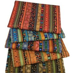 multicolored striped fabrics stacked on top of each other in different sizes and colors