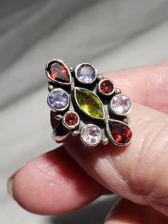 Lovely multi-gem ring in garnet, peridot and amethyst in size 5.25 Lovely vintage condition in sterling silver. Looks like a Nicky Butler ring.  I can send you this lovely ring tomorrow! Multi Gem Ring, Celebrity Engagement Rings, Gem Ring, Lovely Ring, Multi Stone Ring, Multi Stone, Stone Rings, Basement, Garnet