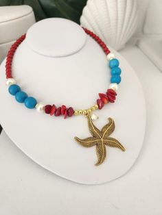 Turquoise and Red Big Starfish Necklace Add a touch of tropical elegance to your outfit with our turquoise and red Big Starfish necklace! This handmade necklace, made with love in Puerto Rico, is a unique piece that captures the essence of the Caribbean and its vibrant beauty.  Main pendant in the shape of a large starfish in Tibetan Brass. Genuine turquoise beads, red magnesites, red coral chips, glass pearls. Hand selected beads to ensure exceptional color and shine. Gold plated stainless stee Red Necklaces For Summer Vacation, Red Necklace For Summer Vacation, Red Summer Vacation Necklaces, Red Summer Vacation Necklace, Multicolor Beaded Turquoise Necklace For Beach, Red Bohemian Jewelry For Beach, Red Bohemian Jewelry For The Beach, Bohemian Red Jewelry For Beach, Red Bohemian Beach Jewelry