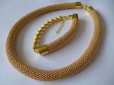 Small Czech seed beads in gold color. Very flexible and comfortable to wear. It is easy, elegant jewelry suitable for everyday use and special occasions. It is handmade especially for you. Necklace length 18.11 inch (46 cm). Bracelet length 9.06 inch (23 cm). Handmade Gold-plated Beaded Bracelets, Elegant Yellow Beaded Bracelets With Gold Beads, Elegant Yellow Beaded Bracelet With Gold Beads, Elegant Handmade Gold Beaded Bracelets, Elegant Gold Handmade Beaded Bracelets, Elegant Gold Beaded Necklace With Spacer Beads, Handmade Adjustable Gold Jewelry Sets, Adjustable Gold Metal Beads, Elegant Handmade Gold Beads