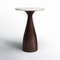 a white table with a brown base and marble top on an isolated surface, in the shape of a cone