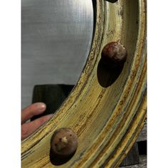 a person is looking at the reflection in a mirror with two snails on it and one snail sticking out of its shell