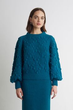 Marisa is an eye-catching, textural sweater with bold blouson knit sleeves. Hand-knit with the softest alpaca yarn in an all over sumptuous popcorn and cable stitch, Marisa looks chunky yet she is extremely light. This piece is perfect to style in a relaxed or polished way, whatever your mood in this teal hue. Also ava Cable Stitch, Alpaca Yarn, Knit Sleeve, Versatile Outfits, Baby Alpaca, Boutique Dresses, Women Pullover, S Models, Modern Woman