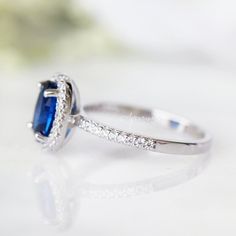 Gorgeous Blue Sapphire Ring ►Made of Sterling Silver with rhodium finish (925) ►Accented with Simulated Diamonds (cz) Center Stone: Sapphire Color: Blue Stone Cut: Oval Gem size: 8.0 x 6.0 mm Gemstone Creation: 100% genuine Lab-Grown sapphire ►Handling time: 1-2 business days ►Free domestic USA shipping ►Wrapped & ready to give in a beautiful box. Classic Gemstone Birthstone Ring For Promise, Classic Promise Ring With Birthstone Gemstone, Classic Birthstone Ring For Promise, Classic Blue Halo Ring With Accent Stones, Anniversary Sapphire Jewelry With Halo Design, Classic Promise Ring With Gemstone, Classic Sapphire Ring Gift, Classic Sapphire Birthstone Promise Ring, Classic Lab-created Sapphire Ring With Halo Design