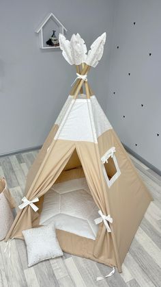 a teepee tent is set up on the floor