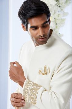 This ivory sherwani set features kiran dori embroidery on the cuffs and a stepper collar detail on a matka silk base. This ensemble is paired with a cotton silk kurta and a stretchable cotton silk trouser. Complimenting footwear is also available.From Seema Gujral's Tuscan Summer collection. DELIVERY TIMEPlease allow 8-12 weeks for your outfit to arrive.FABRIC DETAILSMatka SilkProfessional cleaning only. Luxury Ceremonial Chanderi Sherwani, Luxury White Sherwani With Self Design, Luxury Off-white Sherwani With Intricate Embroidery, Ivory Sherwani, Tuscan Summer, Dori Embroidery, Seema Gujral, Silk Kurta, Silk Trousers