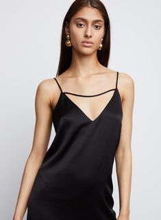 Our Leilani, is a skim slip dress with feather hemline adds a feminine edge to this body skimming slip dress silhouette, crafted in Hammered Satin. Spaghetti straps with horizontal detailing enhance the décolletage. Hemline hits right below the knee. 86% Triacetate 14% Poly Imported Dry Clean Only Model is 5'10 and wears size S Elegant Strappy Slip Dress For Date Night, Chic Backless Camisole With Straps, Sleek Slip Dress With Spaghetti Straps For Summer, Elegant Fitted Strappy Camisole, Chic Strappy Slip Dress For Evening, Chic Strappy Slip Dress For Date Night, Chic Evening Slip Dress With Strappy Design, Chic Evening Slip Dress With Boning, Chic Dresses With Adjustable Straps