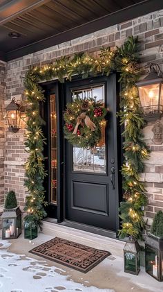 the front door is decorated for christmas with wreaths and lights