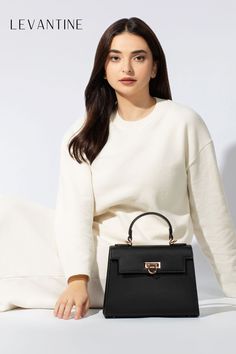 Embrace a classic and timeless style this Winter 2023 with Levantine black handbags paired with all-white cozy outfits. A staple in any fashion capsule, these handbags offer versatility and sophistication across all seasons. Their classic design complements the soft, snug appeal of white outfits, creating a perfect balance of elegance and comfort. #TimelessFashion #Levantinebags #WinterStyle #ClassicTrends #AllWhiteOutfits #FashionEssentials Outfits For Winter 2023, Classic Black Handbag, White Handbags, Beautiful Purse, Fall Bags, Summer Handbags, Vegan Handbags, Stylish Top, White Handbag