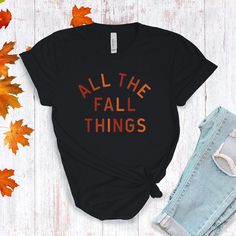 All The Fall Things in a modern font graphic on front in cream or multi Fall colors. Youth Sizes S-XL (unisex sizing) Toddler Sizes 2T, 3T, 4T To view All The Fall Things Adult T-shirts click here.To view All The Fall Things Baby Bodysuit click here.Bella + Canvas4.2 oz. Airlume combed and ring-spun cottonPre-shrunkFor a more relaxed fit, size up! Black Slogan T-shirt For Fall, Fall Short Sleeve T-shirt With Text Print, Trendy Screen Print T-shirt For Fall, Trendy Fall Letter Print T-shirt, Trendy Letter Print T-shirt For Fall, Fall Slogan T-shirt With Relaxed Fit, Fall Graphic Print T-shirt, Cotton T-shirt With Text Print For Fall, Fall Letter Print Short Sleeve T-shirt