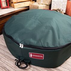 a large round bag sitting on top of a floor next to boxes and other items