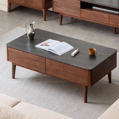 a coffee table with an open magazine on it