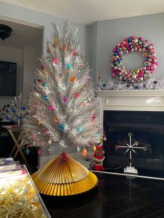 a white christmas tree sitting on top of a wooden table