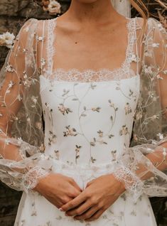 a woman wearing a white wedding dress and veil