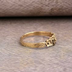 a gold ring with flowers and leaves on it