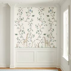 an empty room with white walls and floral wallpaper