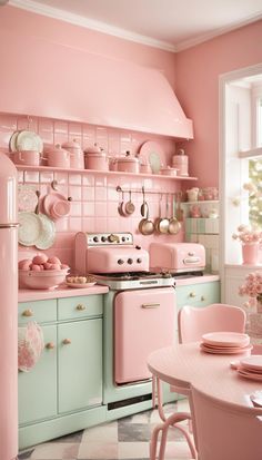 a pink and green kitchen with lots of dishes