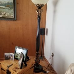 a lamp and some pictures on a table